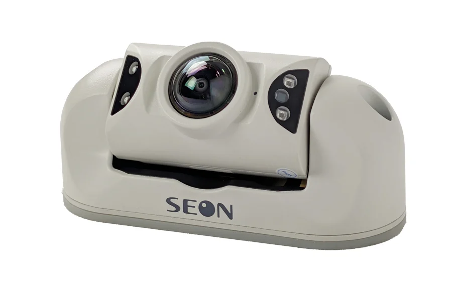 Hd3u | Safe Fleet | Safe Fleet Cream-colored Video Camera on a Rounded Base, with a Large Central Lens and Seon Branding Visible on the Front Base, Plus Led Panels on the Sides of the Lens Housing.
