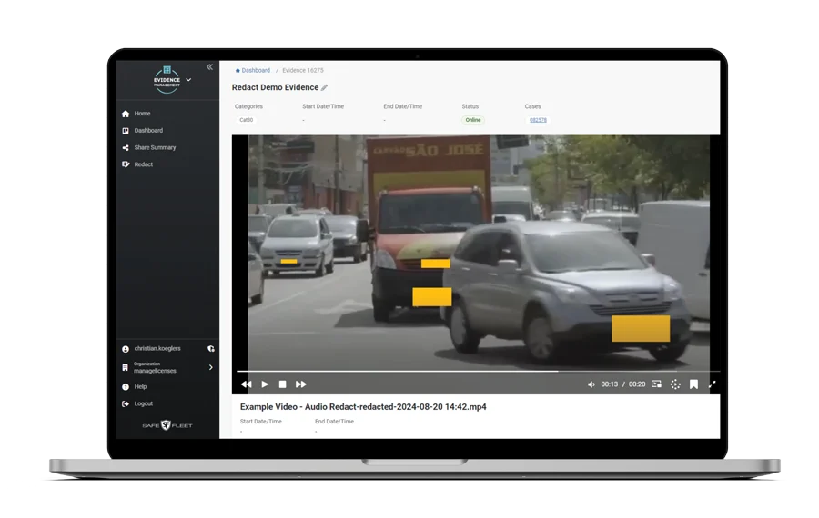 Laptop Showing an Evidence Management Video Player with a Traffic Scene and Orange/redaction Bars Masking Parts of the Frame.